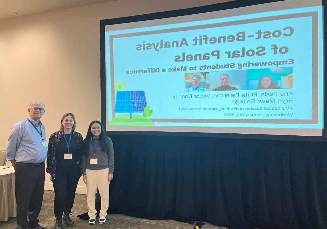 Math students and Victor Donnay in front of presentation titled "Cost-Benefit Analysis of Solar Panels: Empowering Students to Make a Difference"